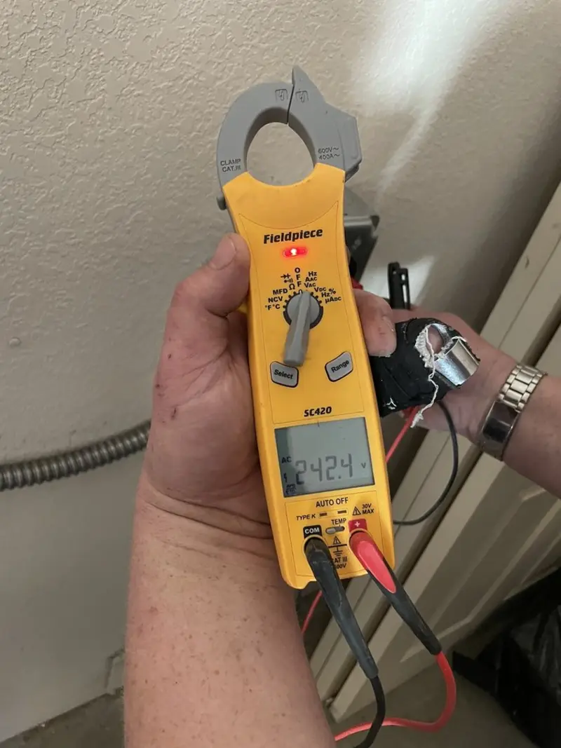 Voltage testing with clamp meter during Ceiling Fan Installation in Walnut
